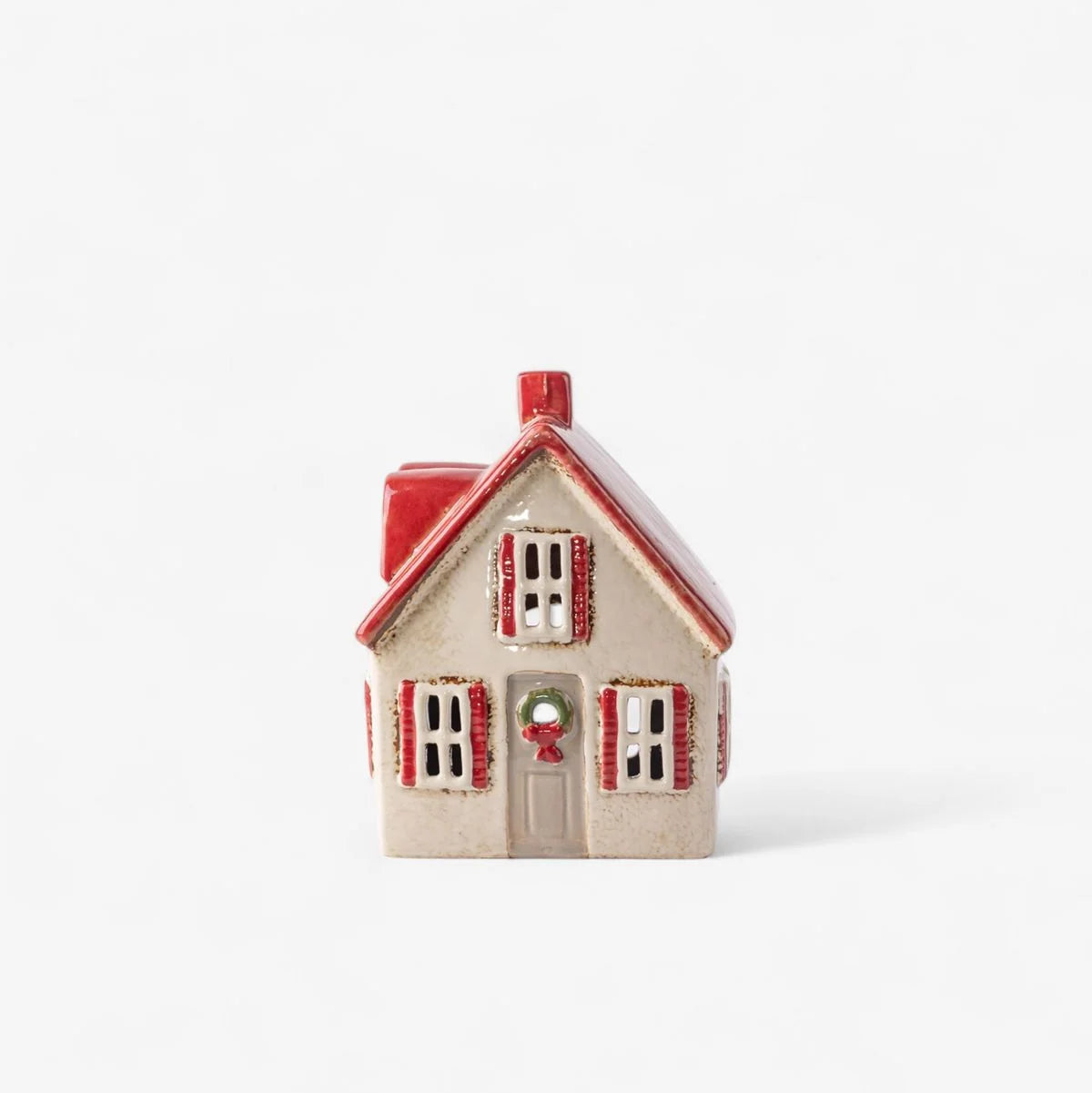 Small decorative house with a red roof on a white background