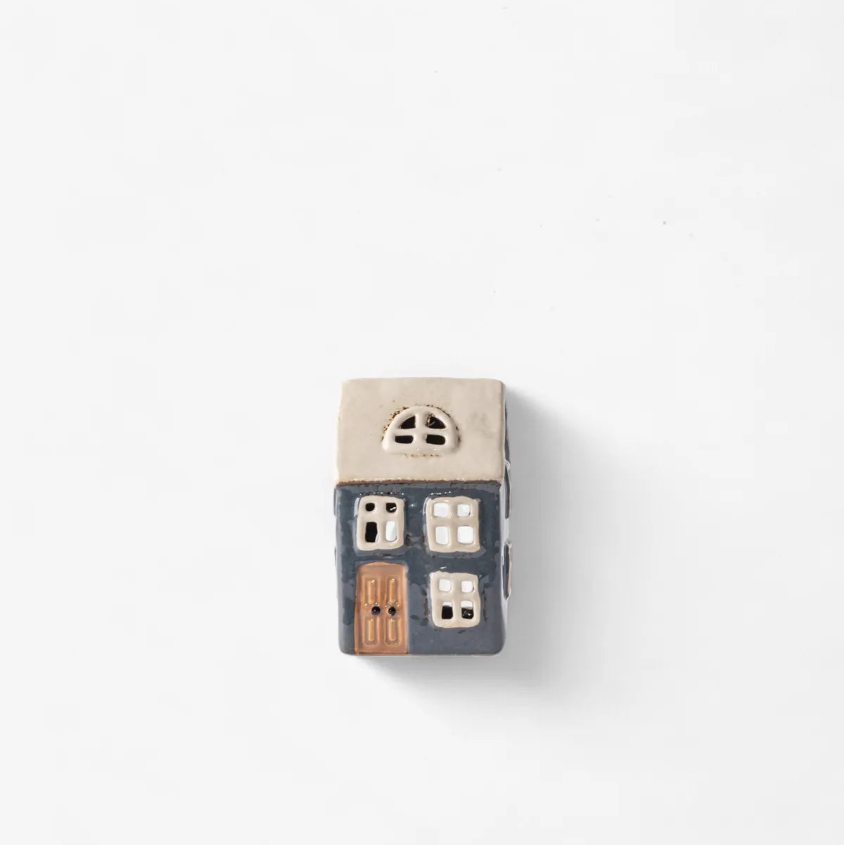 Small ceramic model of a house on a white background