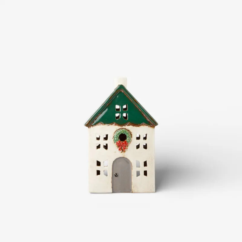 Small ceramic tealight house with a green roof on a white background