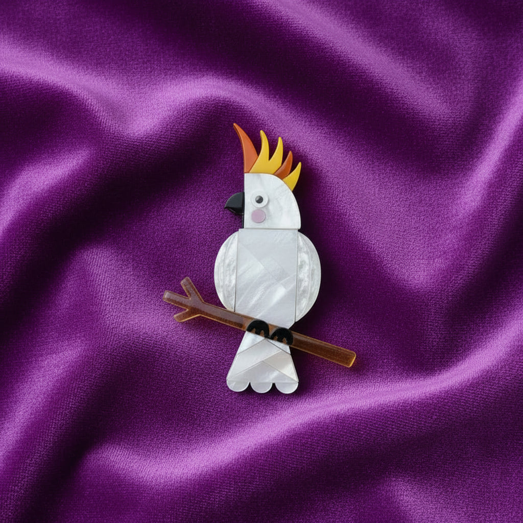 Cockatoo brooch on a yellow background