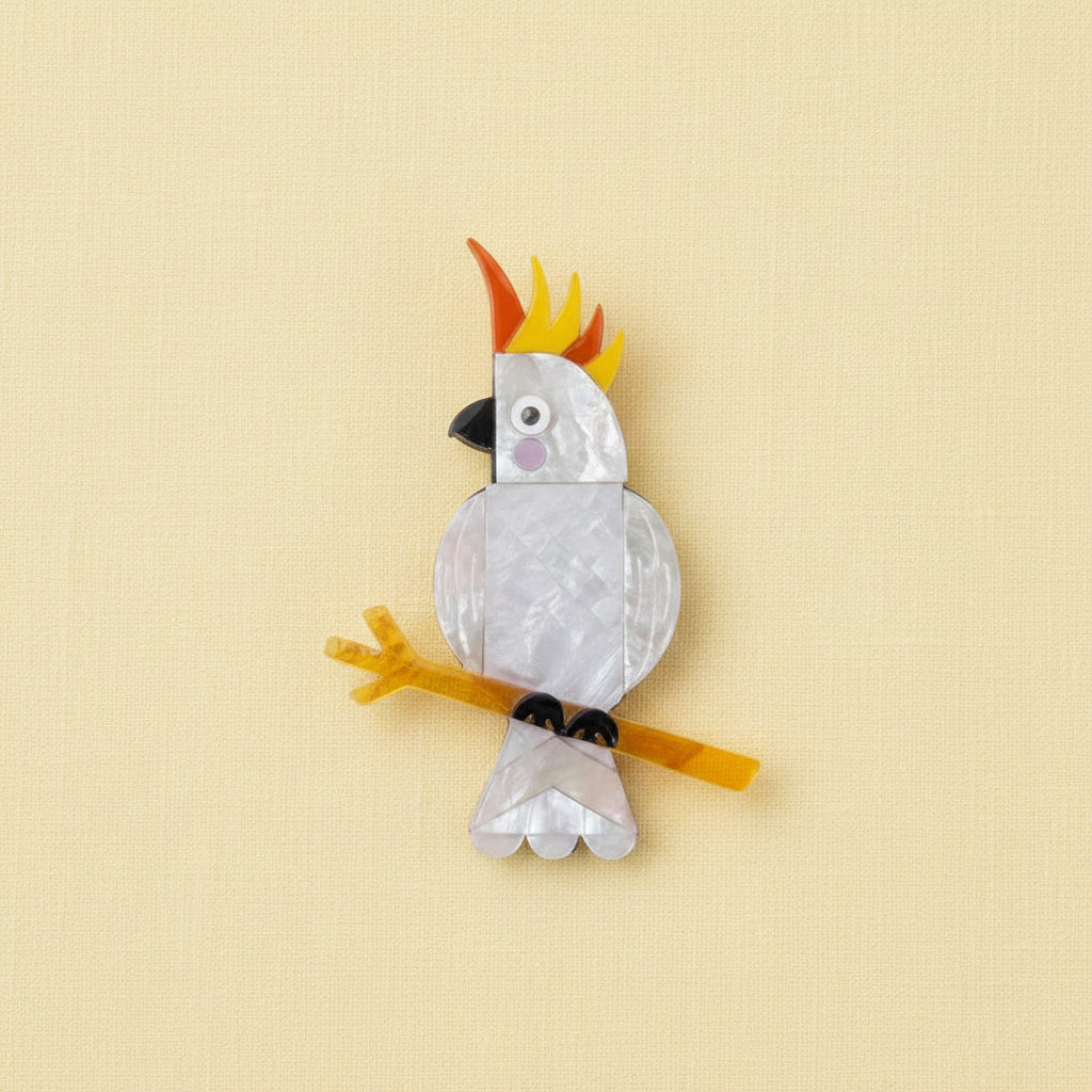 Cockatoo brooch on a yellow background