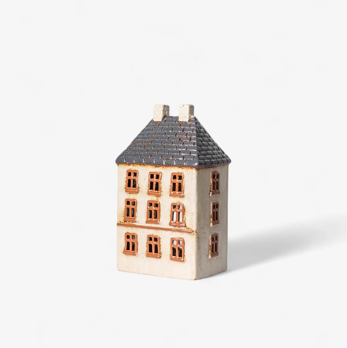 Small ceramic house with a gray roof on a white background