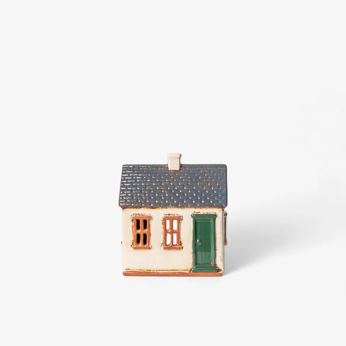 Small ceramic model of a house on a white background