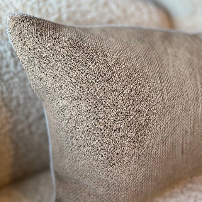 Close-up of linen chenille lumbar cushion on a boucle lounge
