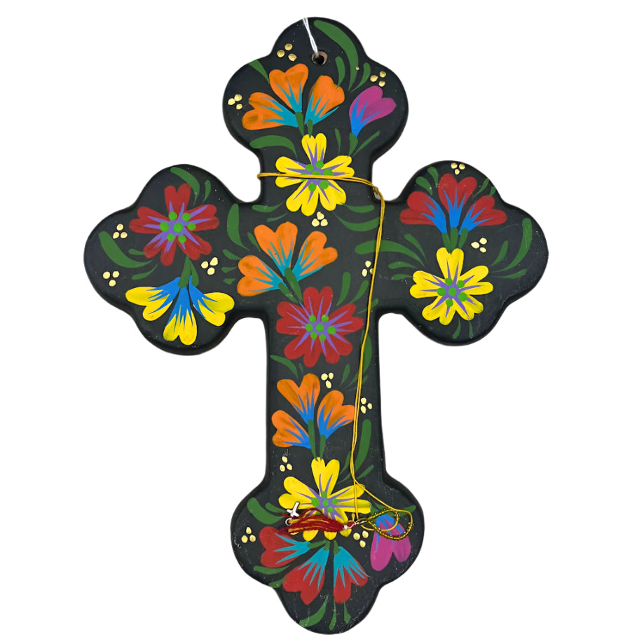 Decorative cross with colorful floral patterns on a wooden surface