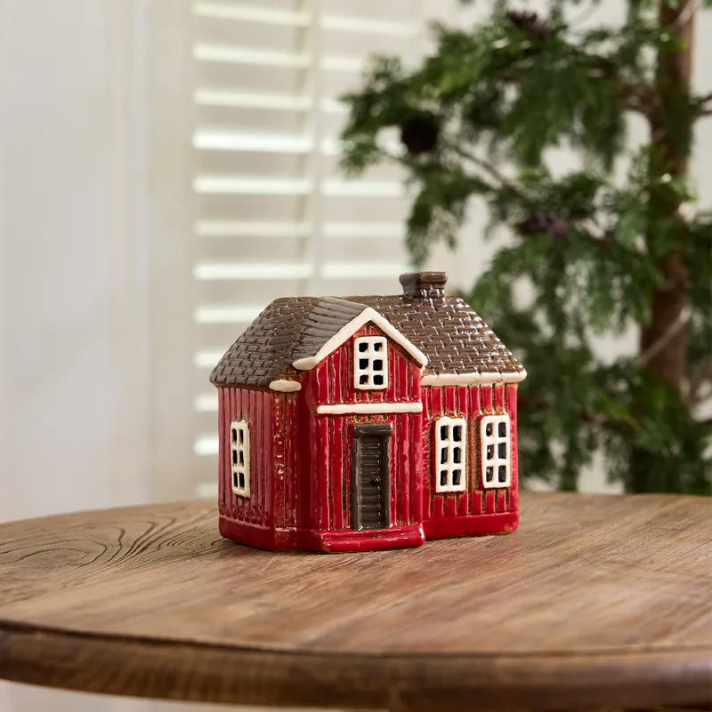 Ceramic Tealight housewooden table with a blurred background