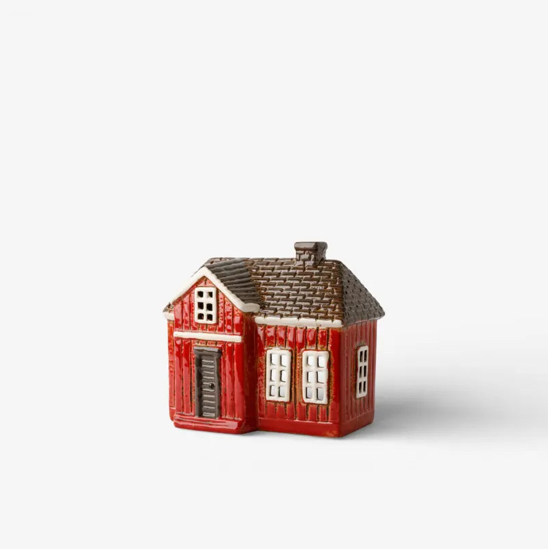 Ceramic Tealight red house-shaped on a white background