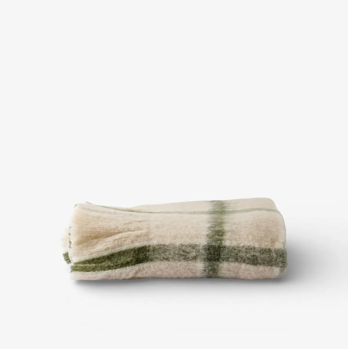 A folded cream-colored wool blanket with a green plaid pattern, photographed on a clean white background.