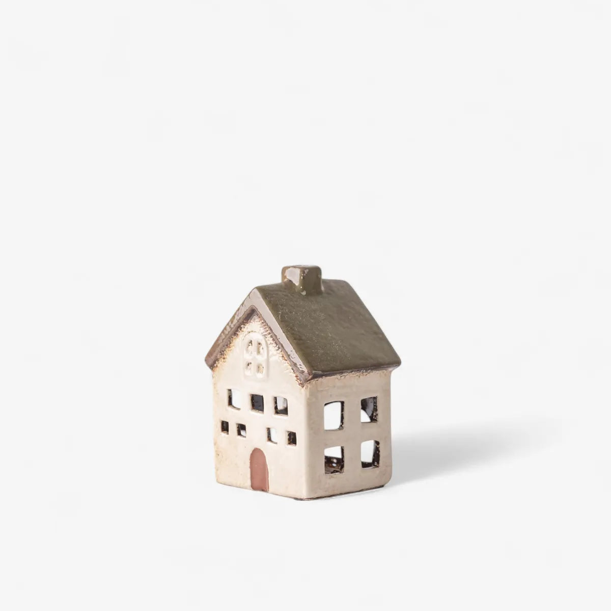 A small ceramic house-shaped candle holder or decorative figurine with a textured beige body, olive green roof, and small arched door, shown on a plain white background.