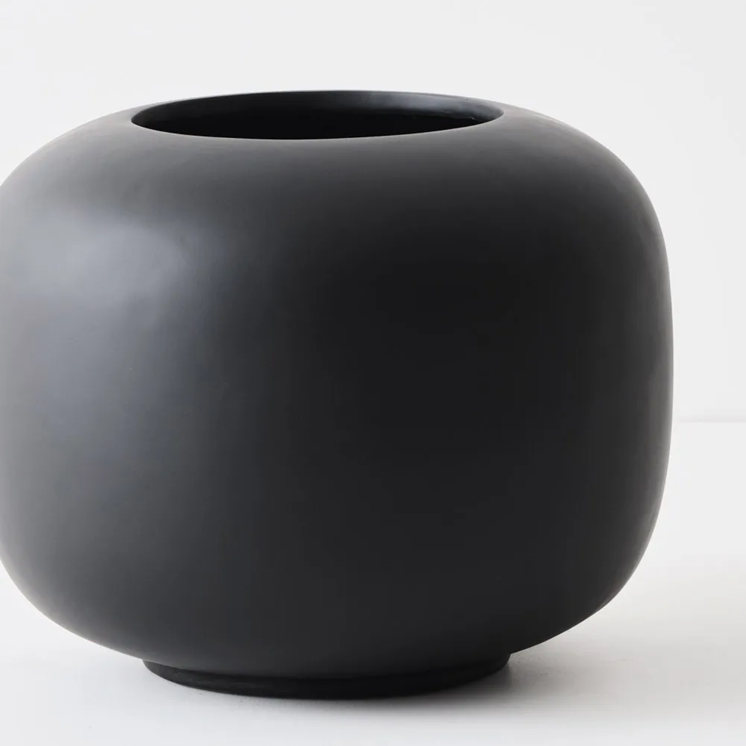 Black ceramic planter on a white background