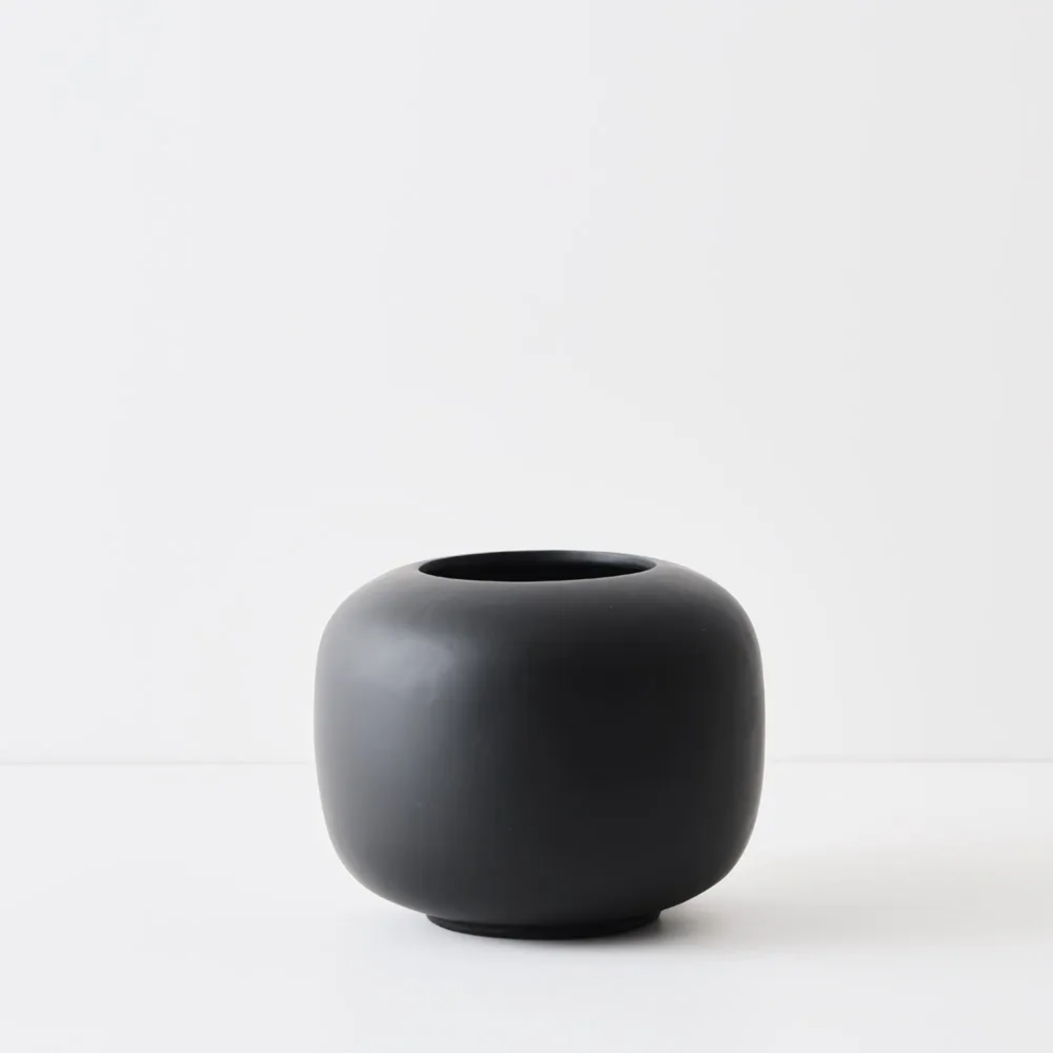 Black ceramic pot on a white background