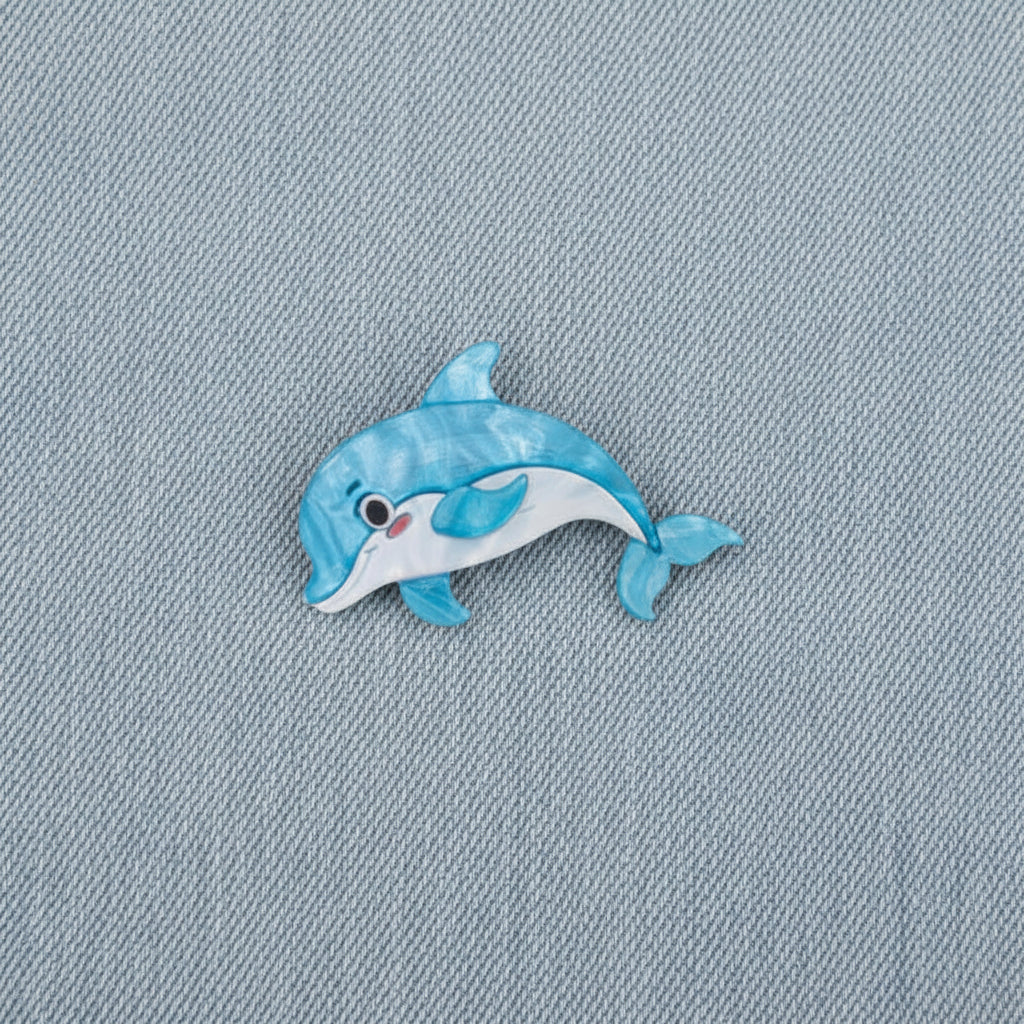 Dolphin Brooch on a denim background
