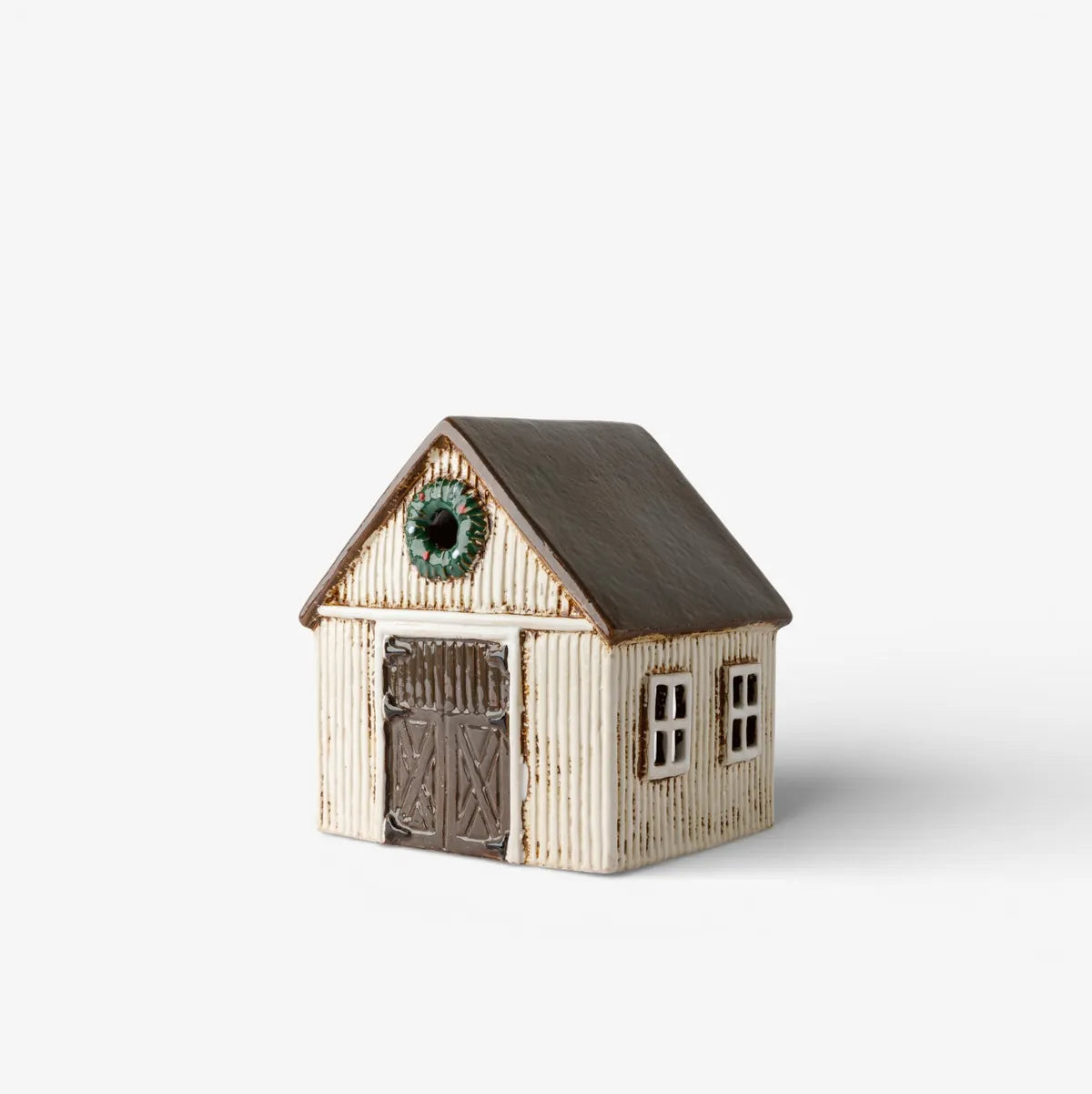 Small model of a house with a brown roof and white walls on a light gray background