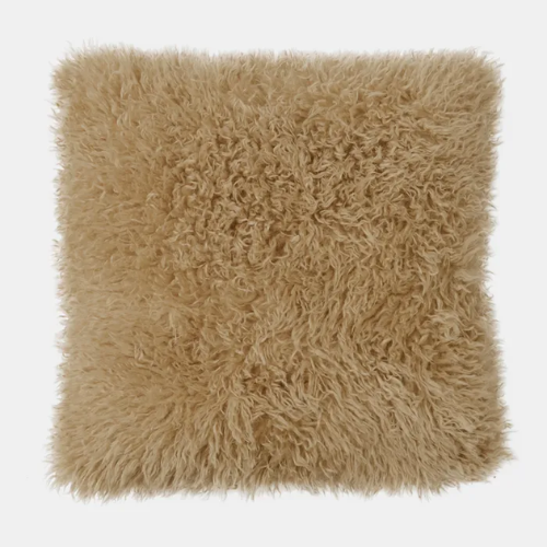 Sand coloured faux fur cushion on a white background