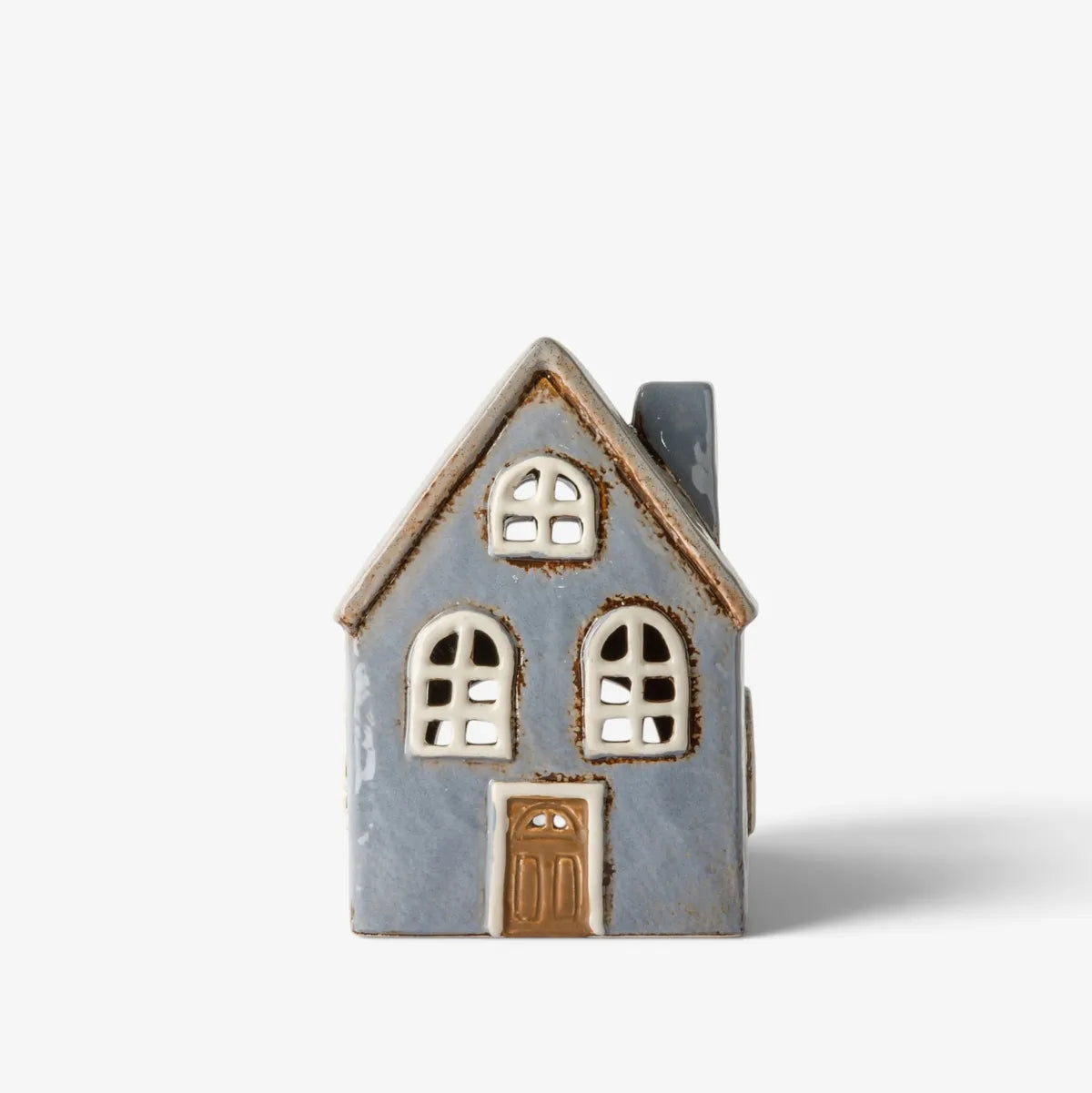A small decorative house-shaped object with a light blue-gray body, cream-colored window and door details, and a brown roof edge, photographed on a clean white background.