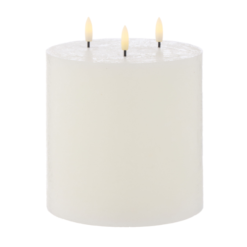 White candle with three lit wicks on a white background