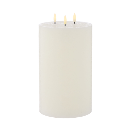 White pillar candle with three LED wicks on a white background