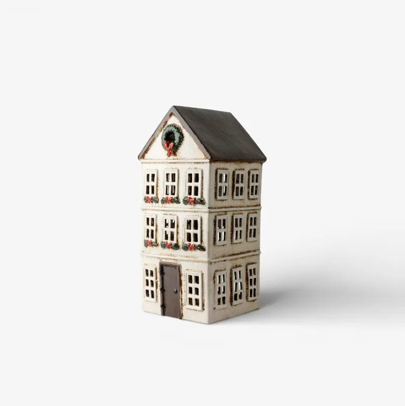 Ceramic Tealight house with decorative elements on a white background