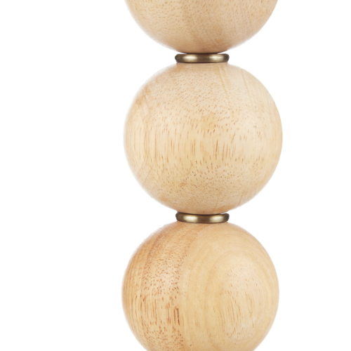 Stack of three wooden spheres with brass accents on a white background