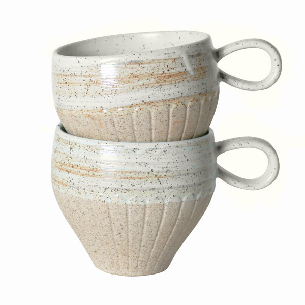 two stacked handmade stoneware mugs with speckle detai.